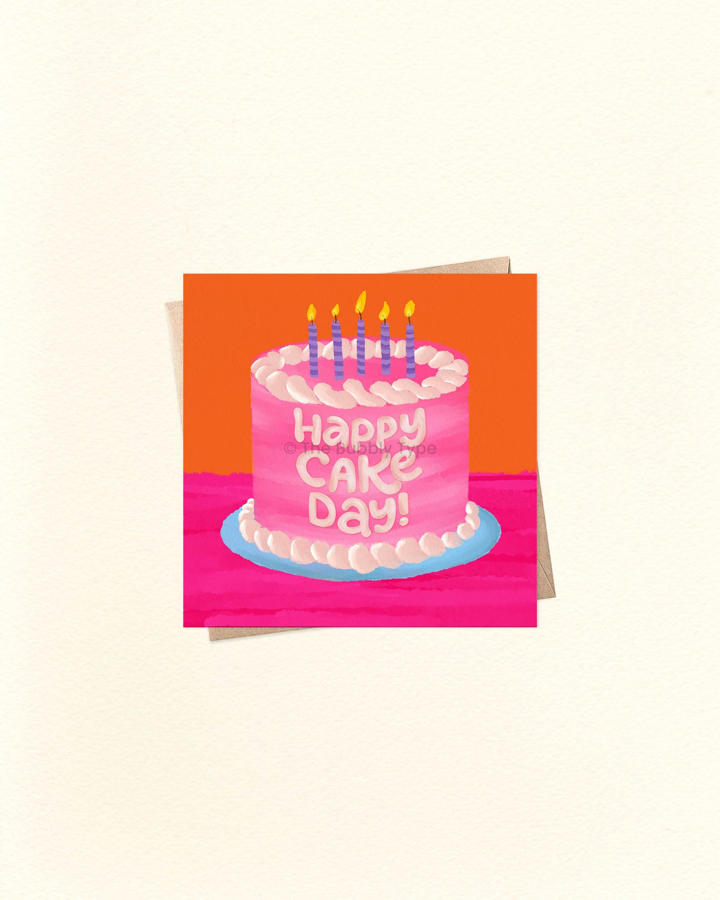 Small square birthday card featuring colourful cake illustration and ‘Happy Cake Day’ message, photographed on top of a brown kraft envelope. Buy fun birthday cards in Australia for cake lovers and party people.