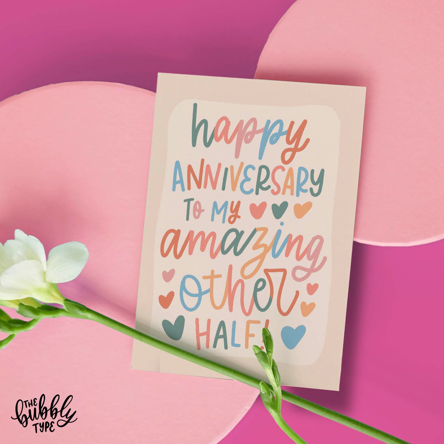 Australian made Love and Anniversary Greeting Cards. Happy anniversary to my amazing other half. Cute card for wife. Fun card for husband. Front of A6 anniversary card featuring whimsical cursive hand-lettering that reads: “happy anniversary to my amazing other half.” Lettering appears in soft neutral tones including dusky sage green, pale pink, peachy orange, and powder blue over a cream background.