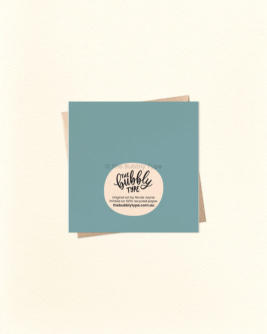 Back of the card with a blue background, displaying The Bubbly Type logo and print details. Shown with a kraft brown envelope. Designed and printed in Australia using eco-friendly cardstock.