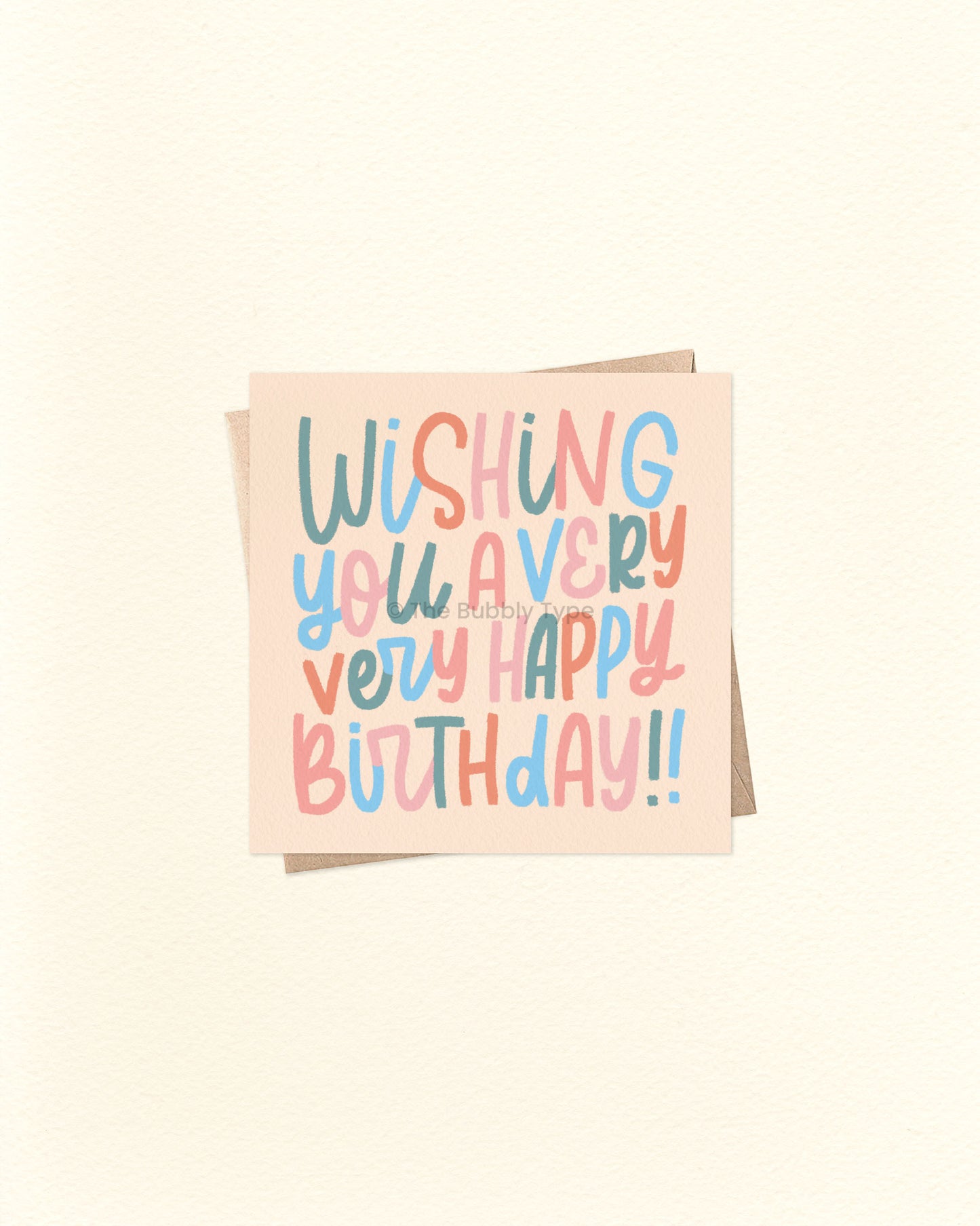 Front of 10cm square birthday card with hand-lettered text reading “Wishing You a Very Very Happy Birthday!!” in whimsical lettering. Features a colour palette of green, blue, orange, and pale pink on a soft orangey beige background. Paired with a brown kraft envelope. A fun and playful birthday card by The Bubbly Type – proudly Australian made.