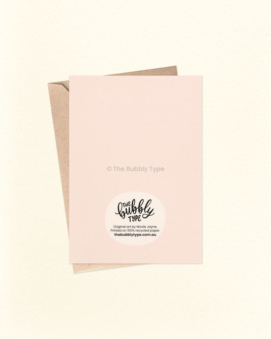 Back of the card with a cream background, featuring The Bubbly Type logo and card details. Displayed with a kraft brown envelope. Printed in Australia on eco-friendly materials.