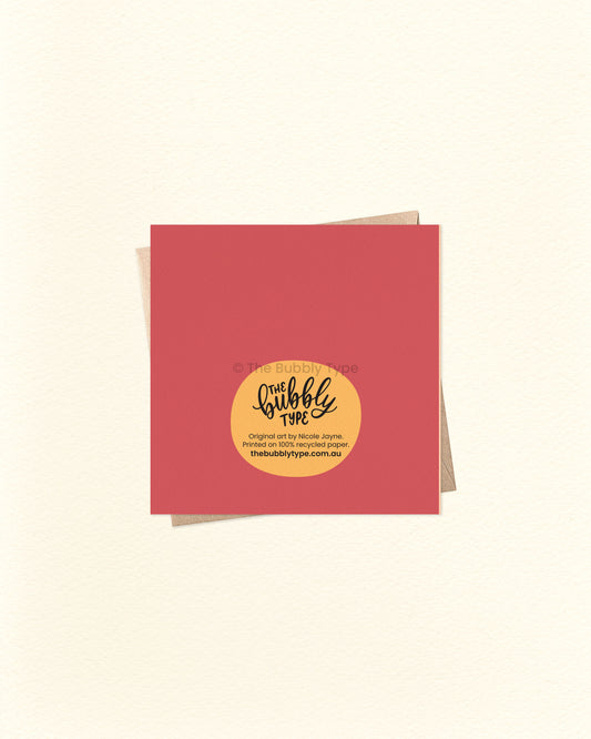 Back of the card with a maroon and yellow background, showing The Bubbly Type logo and print details. Shown with a kraft brown envelope. Designed and printed in Australia using eco-conscious materials.