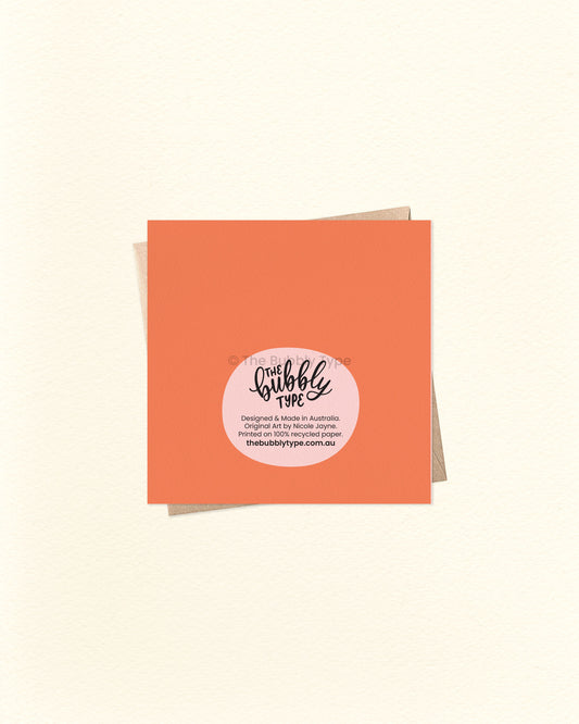 Back of the card with a bright orange background, displaying The Bubbly Type logo and print details. Shown with a brown kraft envelope. Designed and printed sustainably in Australia.