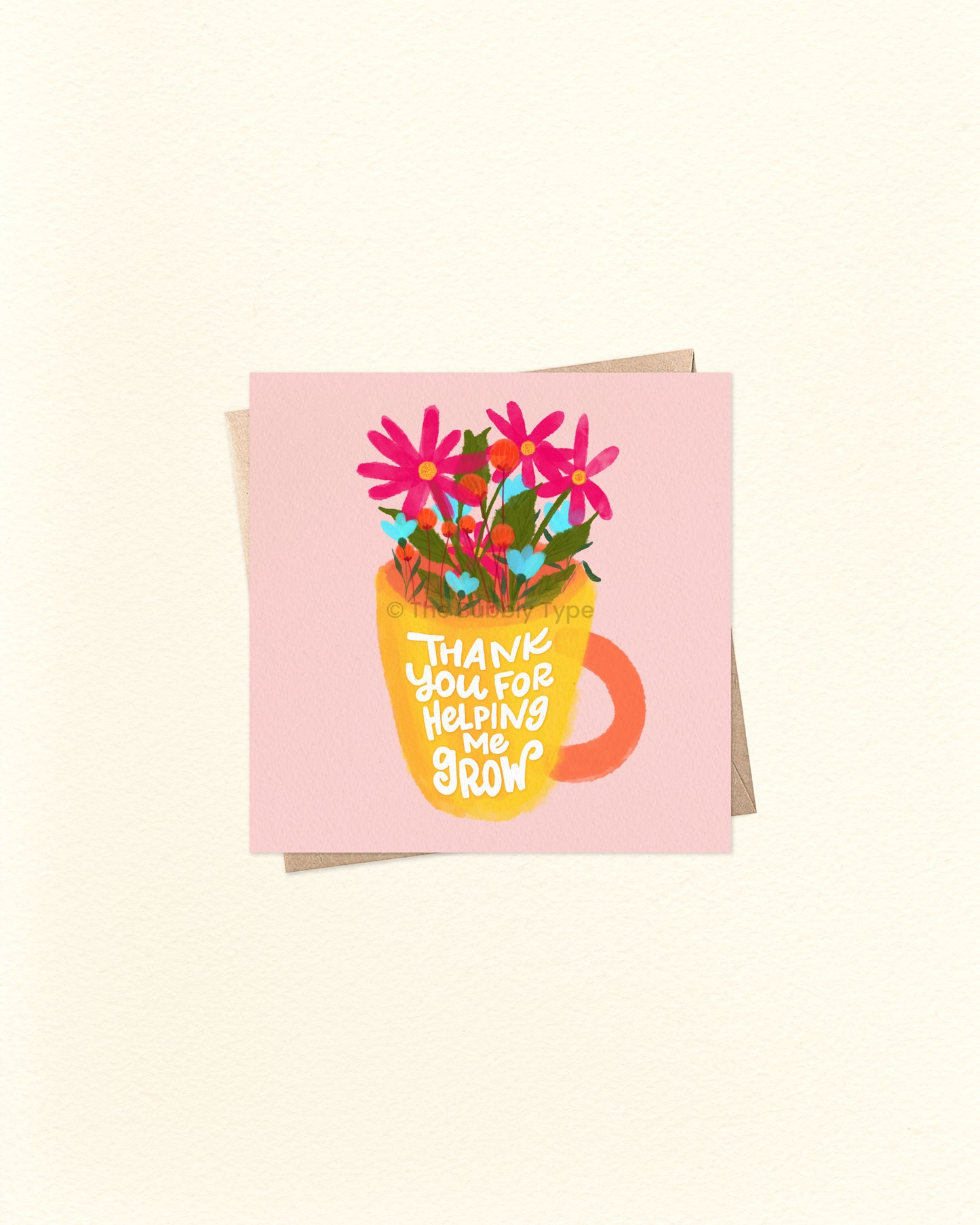 Front of 10cm square greeting card featuring a yellow mug with an orange handle, filled with colourful pink and blue flowers. The mug reads “Thank You for Helping Me Grow” in playful lettering. Paired with a brown kraft envelope. A sweet, Australian made thank you card by The Bubbly Type – perfect for teachers, mentors, or anyone who’s made a positive impact.