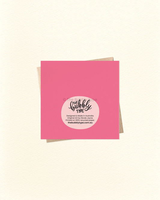 Back of the card with a pink background, featuring The Bubbly Type logo and print details. Shown with a kraft brown envelope. Printed sustainably in Australia.
