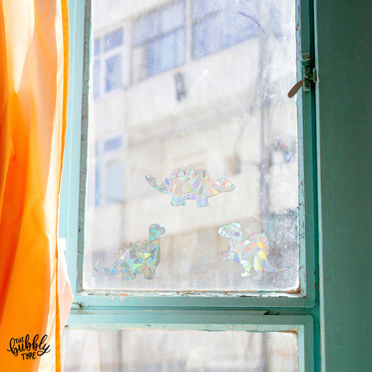 rainbow making sun catcher window sticker decals in the shape of dinosaur sun catchers. Dinosaur gift for kids for christmas.