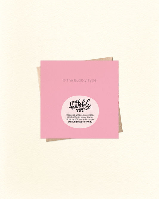 Back of the thank you card with pink background, displaying The Bubbly Type logo and print details. Printed in Australia on eco-friendly cardstock. Shown over a kraft brown envelope.