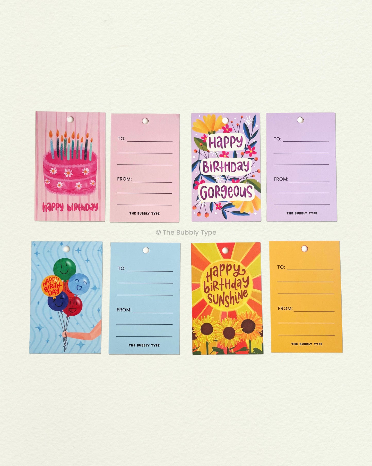 Flat lay of all four birthday tag designs showing front and back. Features party hats, cakes, confetti and more. Great for adding cheer to any birthday gift.