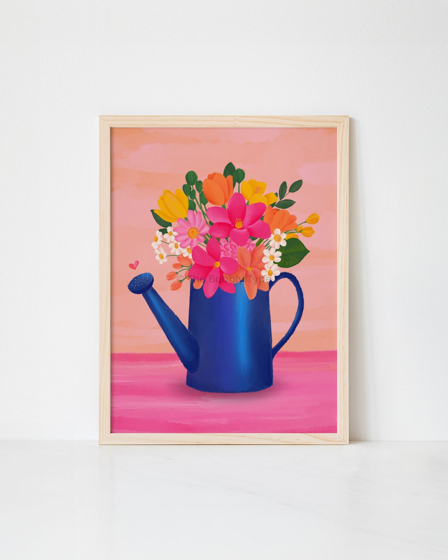 Framed artwork print of a blue watering can with colourful flowers on a pink background