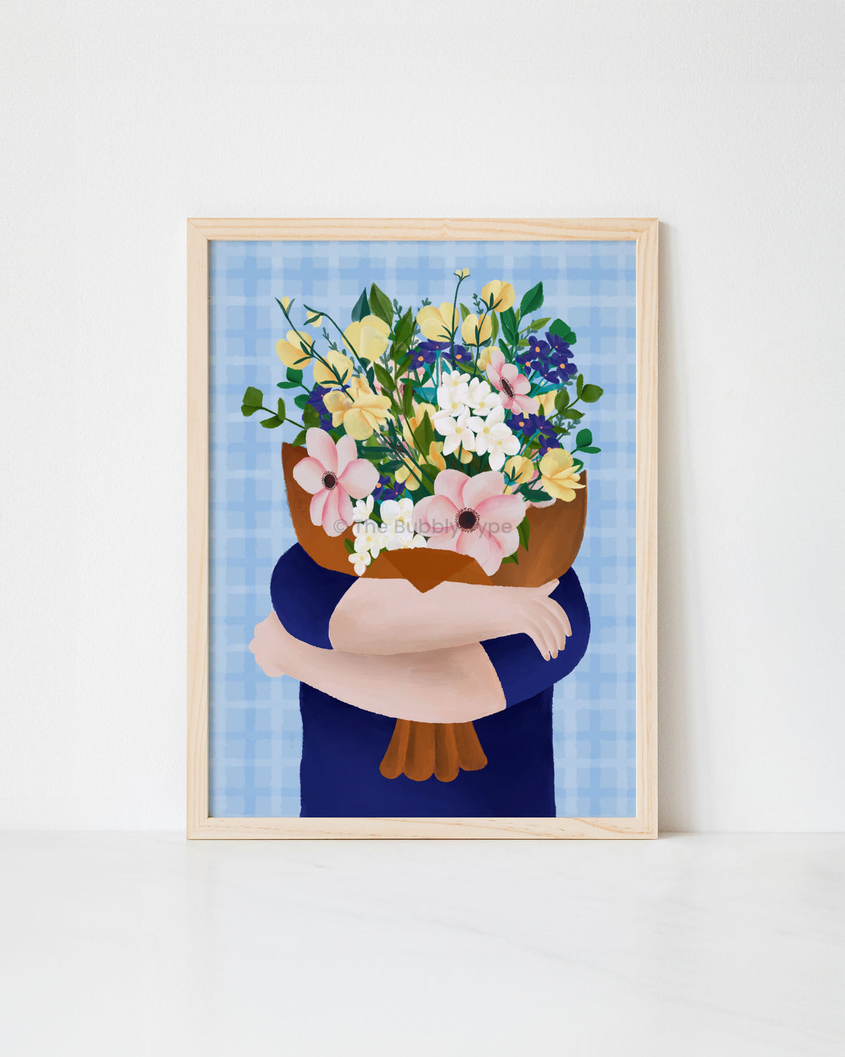 Framed artwork print of a person holding a bouquet of flowers against a blue gingham background