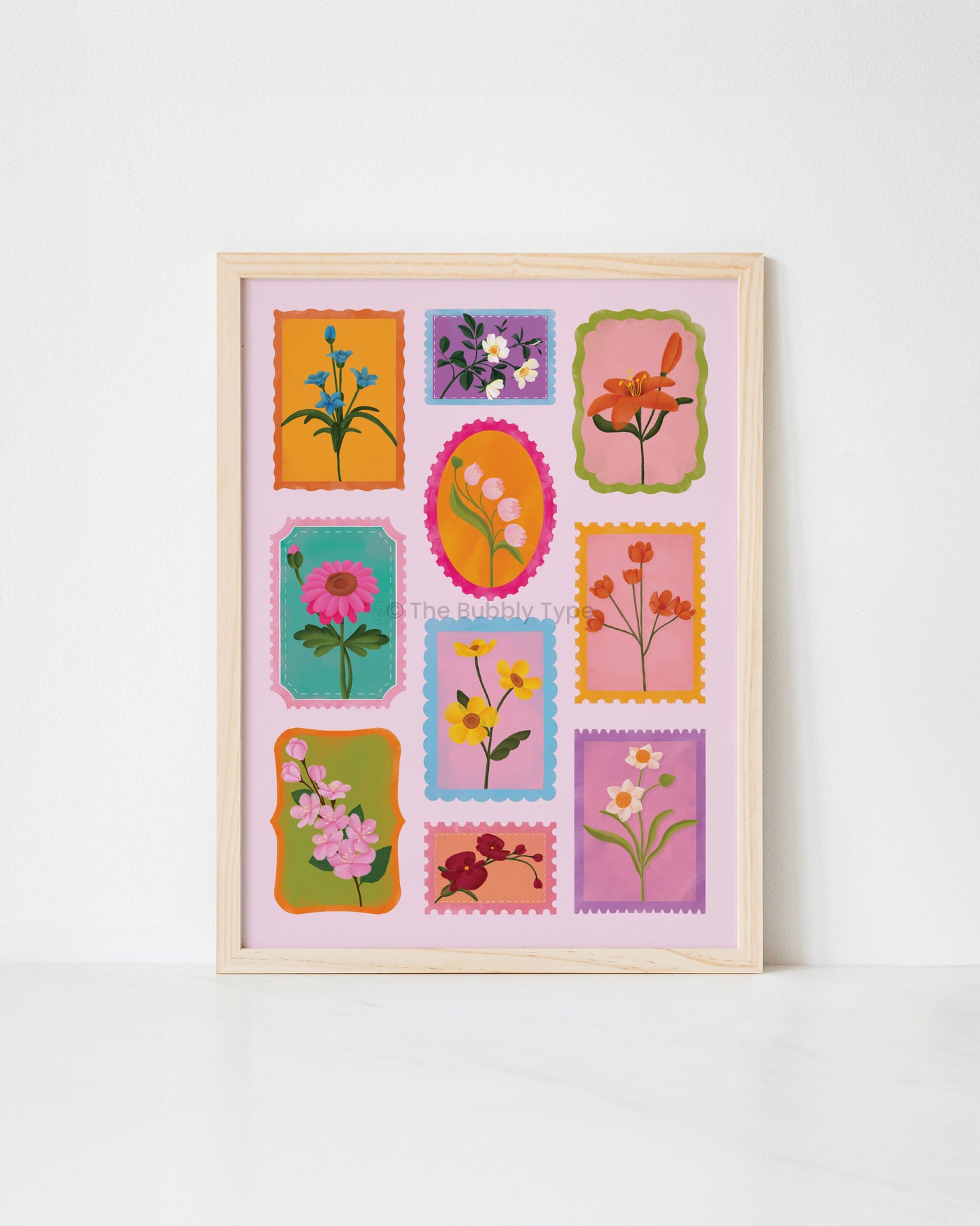 Framed artwork print with colourful floral stamps on a white background
