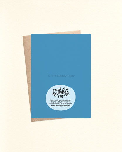 Back of the card with a medium blue background, featuring The Bubbly Type logo and card details. Shown with a kraft brown envelope. You're the best dad card for fathers day.