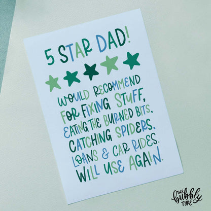 Australian Made Fathers Day Card - 5 Star Dad. Would recommend for fixing stuff, eating the burned bits, catching spiders, loans and card rides. will use again. Front of A6 Father’s Day card with hand-lettered text that reads: “5 Star Dad. Would recommend for fixing stuff, eating the burned bits, catching spiders, loans and car rides. Will use again.” The playful mix of block and cursive lettering is in blues and greens on a pale blue background. Displayed with a brown kraft envelope.