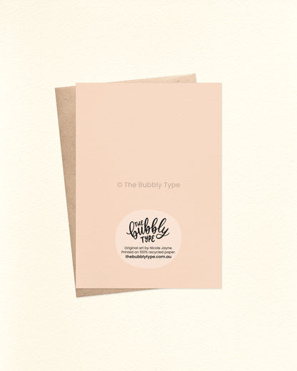 Back of the card with a cream background, displaying The Bubbly Type logo and card details. Printed on 100% recycled paper in Australia. Shown with a kraft brown envelope.