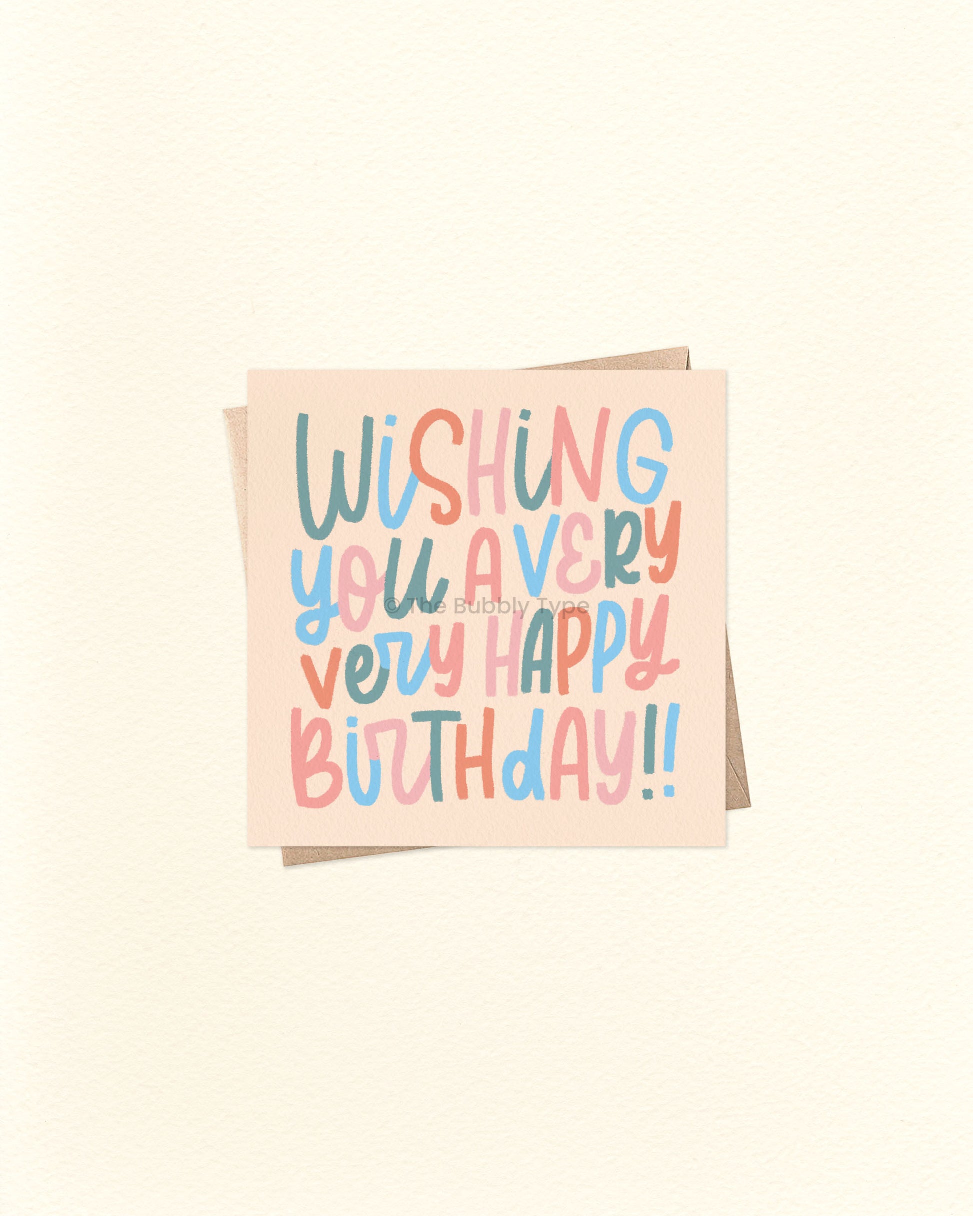 Front of 10cm square birthday card with hand-lettered text reading “Wishing You a Very Very Happy Birthday!!” in whimsical lettering. Features a colour palette of green, blue, orange, and pale pink on a soft orangey beige background. Paired with a brown kraft envelope. A fun and playful birthday card by The Bubbly Type – proudly Australian made.