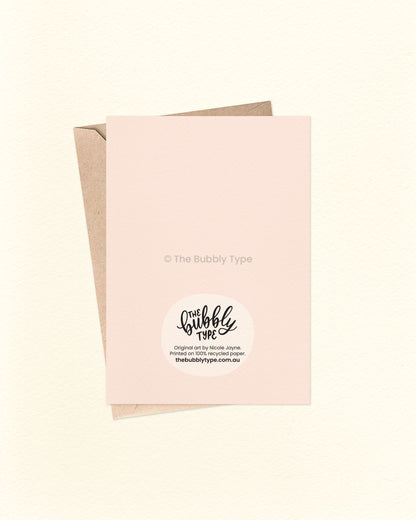 Back of the card with a cream background, featuring The Bubbly Type logo and card details. Displayed with a kraft brown envelope. Printed in Australia on eco-friendly materials.