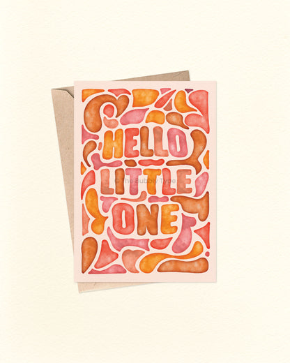 Front of A6 greeting card featuring a warm watercolour abstract design in yellows, oranges, and browns, with the hand-lettered message “Hello Little One” surrounded by soft flowy shapes. This Australian made card by The Bubbly Type is perfect for welcoming newborn babies and celebrating new parents. Shown with a brown kraft envelope.