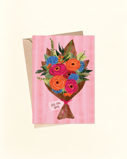 Front of A6 everyday greeting card featuring a watercolour-style illustration of a rose bouquet in pink, orange, and blue, with lush green foliage and a brown paper wrapper. A small tag at the base reads “Just For You.” Set against a soft pink watercolour background and paired with a brown kraft envelope. A heartfelt and versatile Australian made card by The Bubbly Type – perfect for thank yous, celebrations, or everyday moments.
