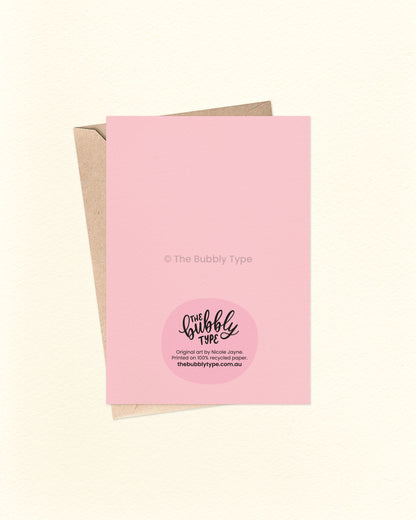 Back of the card with a pink background, featuring The Bubbly Type logo and card details. Displayed with a kraft brown envelope. Proudly designed and printed in Australia on sustainable materials.