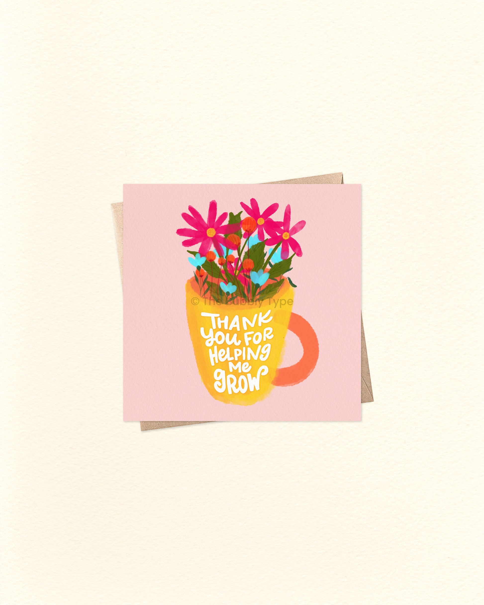 Front of 10cm square greeting card featuring a yellow mug with an orange handle, filled with colourful pink and blue flowers. The mug reads “Thank You for Helping Me Grow” in playful lettering. Paired with a brown kraft envelope. A sweet, Australian made thank you card by The Bubbly Type – perfect for teachers, mentors, or anyone who’s made a positive impact.