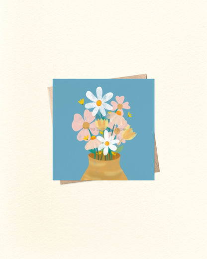 Square card with soft floral illustration and the words ‘Thinking of You’, laid on a brown kraft envelope. Buy unique sympathy or encouragement cards in Australia for friends going through tough times.