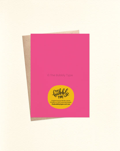 Back of the card is hot pink and features The Bubbly Type logo and card details. Shown with a kraft brown envelope. Printed on 100% recycled paper in Australia.