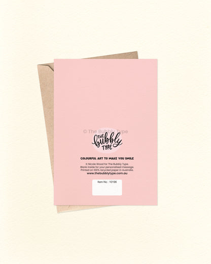 Back of the card with a pale pink background featuring The Bubbly Type logo and card details. Displayed over a kraft brown envelope.