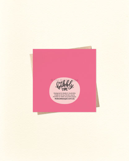 Back of the card with a pink background, featuring The Bubbly Type logo and print details. Shown with a kraft brown envelope. Printed sustainably in Australia.