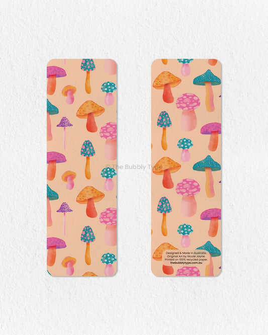 Psychedelic Mushroom Wonderland Bookmark 🍄🌈 – Step into a world of whimsy with this vibrant pale orange bookmark, bursting with a rainbow of colorful mushrooms! With its psychedelic-inspired design and bold, playful aesthetic, this bookmark is perfect for lovers of fun, funky, and retro vibes. Printed on 100% recycled paper, it’s double-sided, high-quality, and finished with rounded corners for a sleek touch. A must-have for anyone who loves mushrooms, magical forests, and groovy colours!
