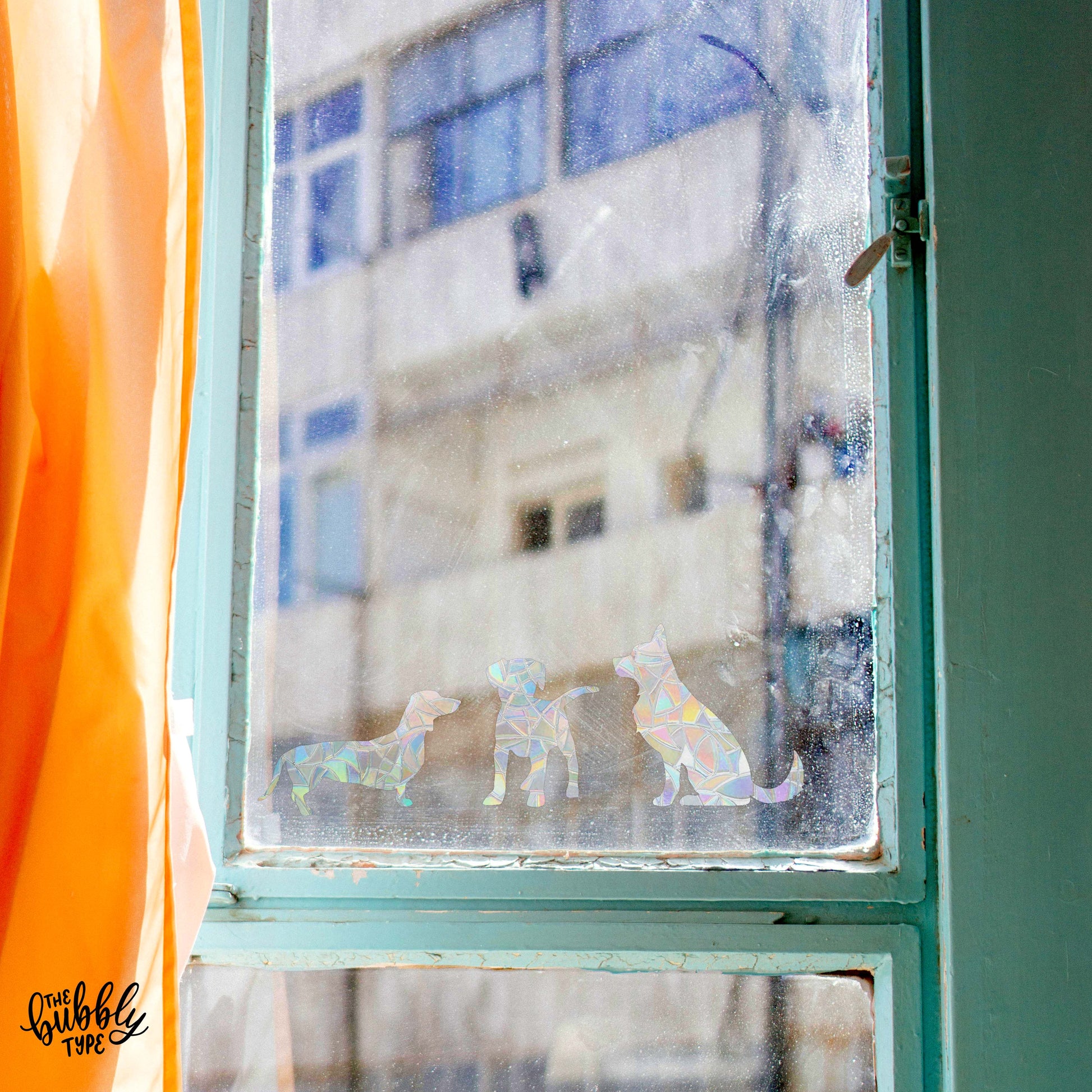 window decoration of dog stickers that make rainbows when the sun catches. Sun catcher window stickers for boho decor.
