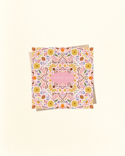 Front of 10cm square thank you card featuring a symmetrical tile-style watercolour pattern with “Thank You” written in the centre. Paired with a brown kraft envelope. Australian made card by The Bubbly Type – a colourful and heartfelt way to show appreciation.
