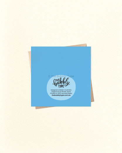 Back of the card with a solid blue background, featuring The Bubbly Type logo and print details. Displayed with a kraft brown envelope. Printed in Australia on eco-friendly cardstock.