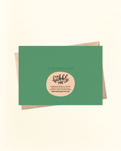 Back of the card with a green background, displaying The Bubbly Type logo and print details. Shown with a kraft brown envelope. Designed and printed sustainably in Australia.