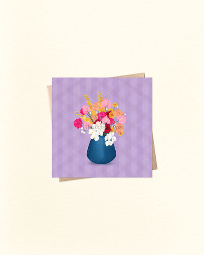 Front of square greeting card featuring a colourful illustrated vase of flowers on a purple background, paired with a brown kraft envelope. Small 10cm x 10cm card by The Bubbly Type – Australian made, blank inside, perfect for thank you notes, birthdays, or just because.