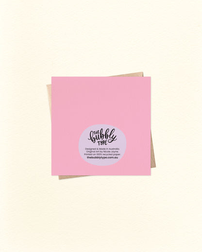 Back of the 10cm square greeting card shown with a pink background, featuring The Bubbly Type logo and printed production details. Proudly designed and printed in Australia using sustainable cardstock.