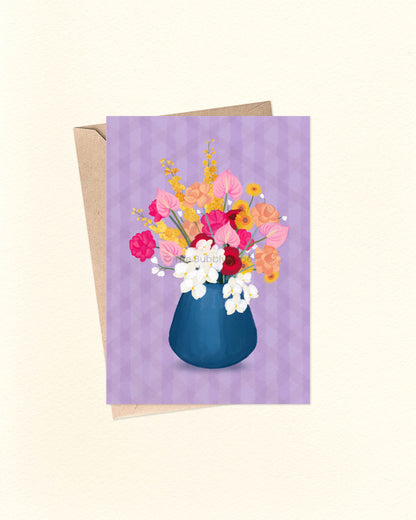 A delicate and elegant design featuring a rounded navy vase filled with colourful floral blooms, all set against a soft lavender background. A beautiful choice for any occasion—whether it's a birthday, a thank-you, or just because. This card is blank inside, giving you plenty of space to write your own heartfelt message. Featuring an original design by an Australian artist, it’s proudly 100% made and designed in Australia. Printed on thick 300gsm card stock made from 100% post-consumer recycled paper.
