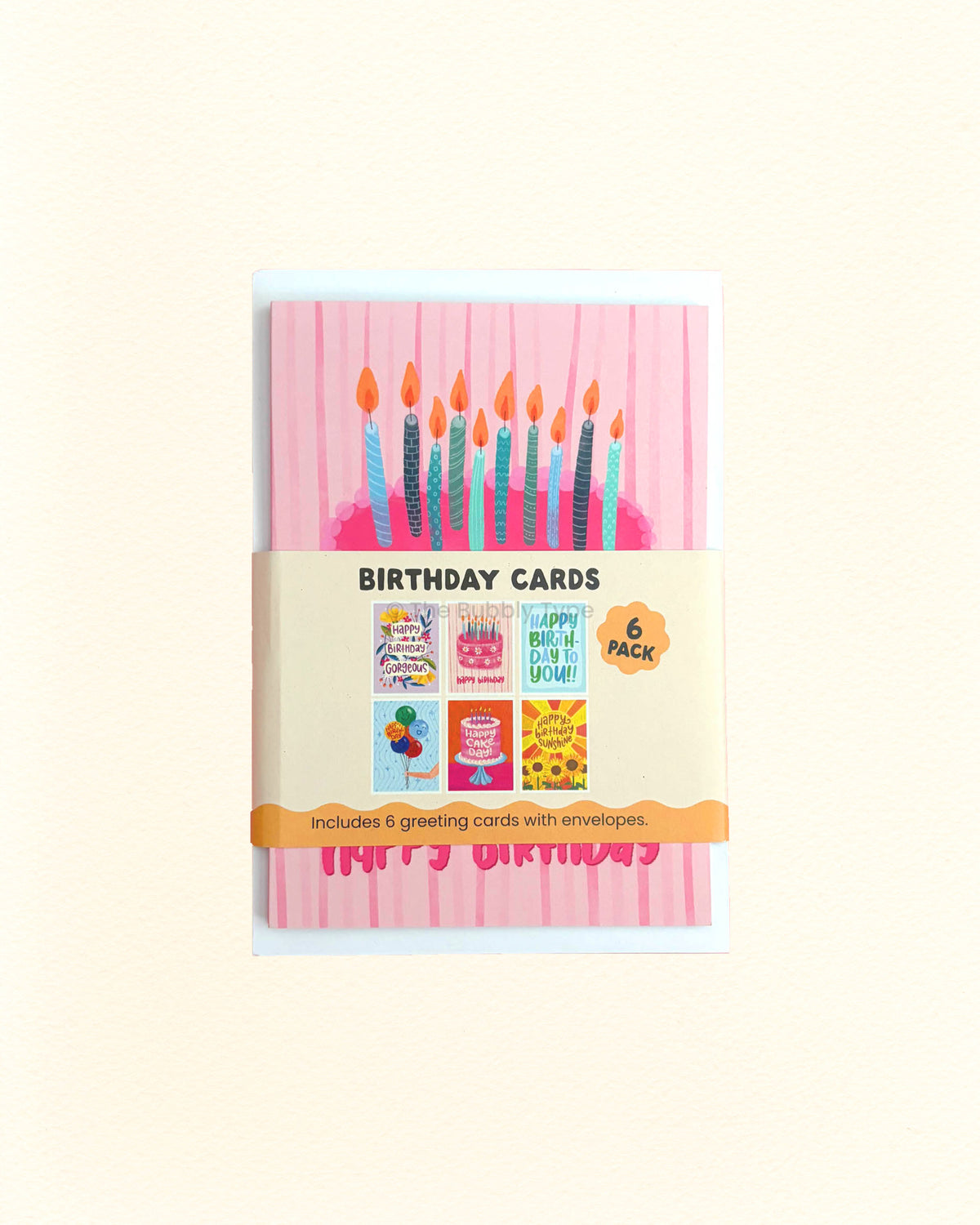 A 6-pack of birthday cards in a clear plastic sleeve with a paper band label. The front card features a pink striped background with colourful birthday candles and a pink 'Happy Birthday' banner.