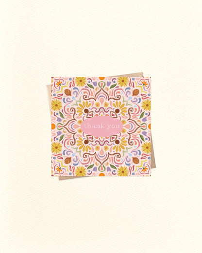 Decorative card with floral pattern and 'Thank you' text on a beige background