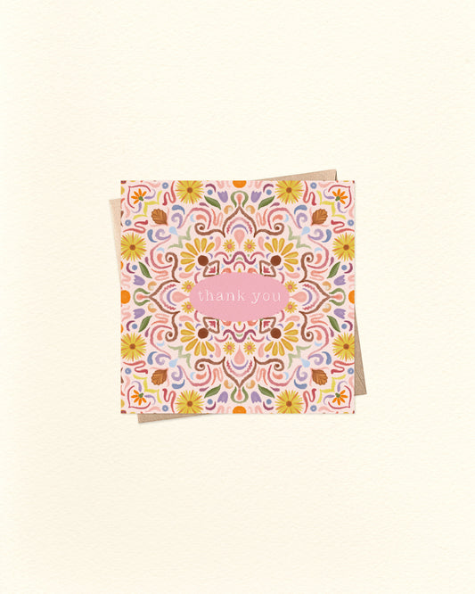 Decorative card with floral pattern and 'Thank you' text on a beige background