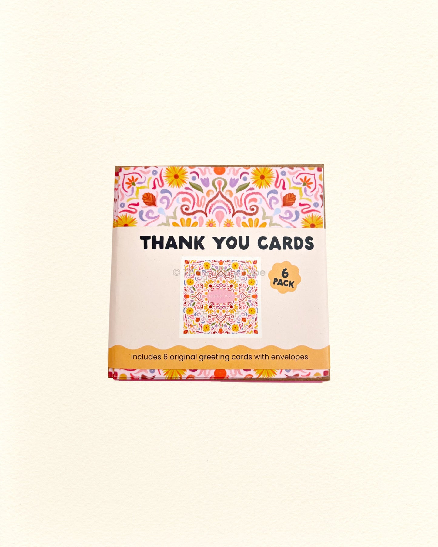 Box of thank you cards with floral design on a white background