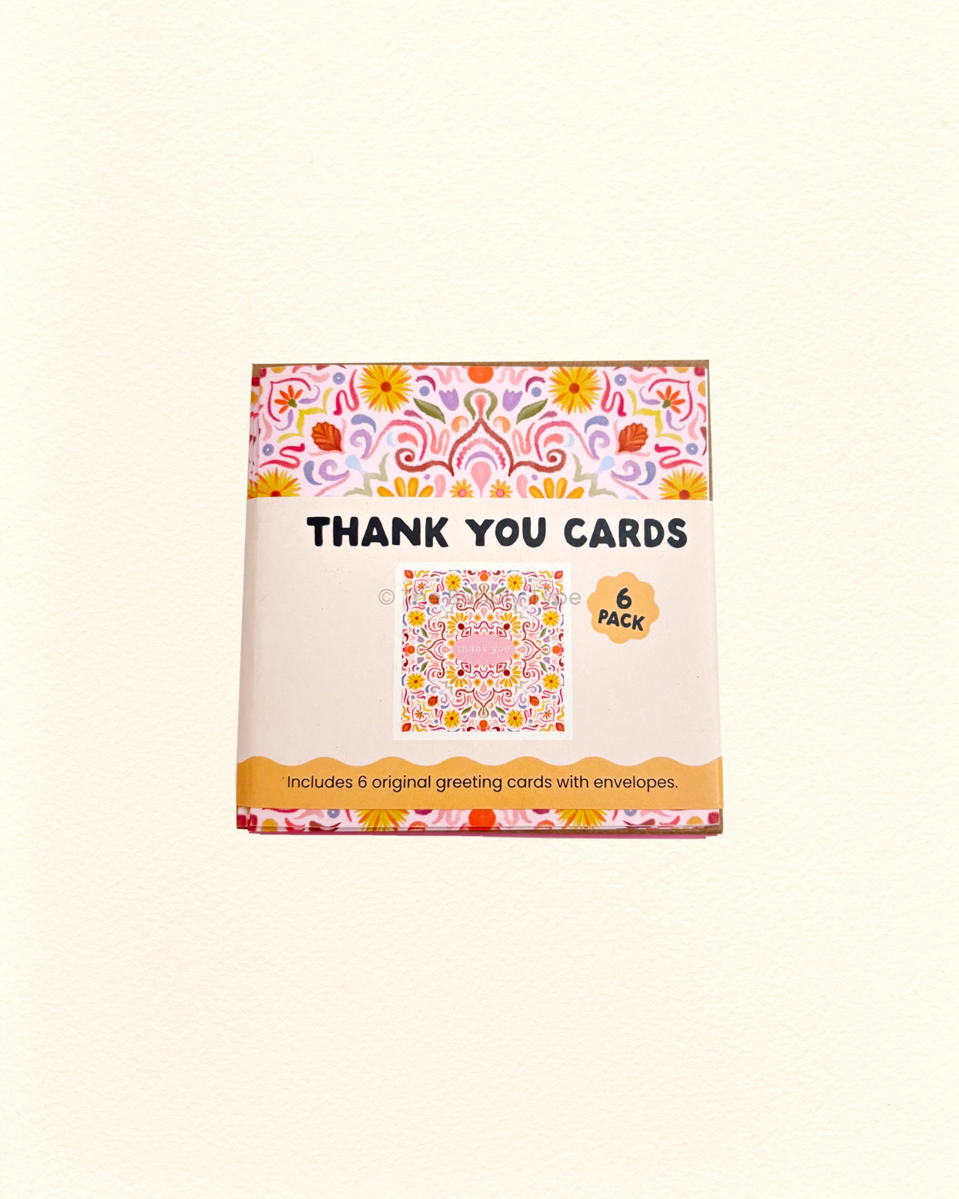 Box of thank you cards with floral design on a white background