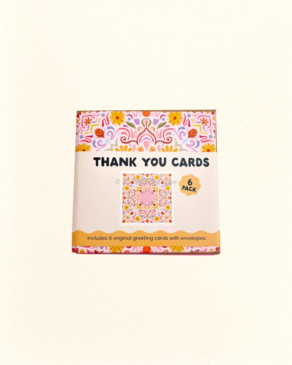 Box of thank you cards with floral design on a white background