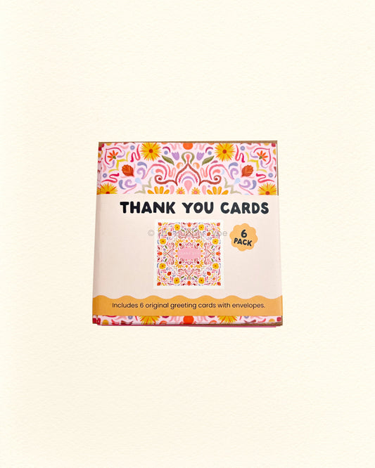 Box of thank you cards with floral design on a white background