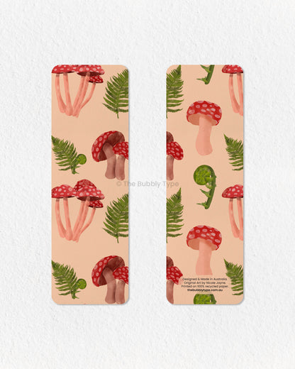 Nature-Inspired Fern & Mushroom Bookmark 🌱🍄 – Bring the beauty of the forest to your reading with this fern and mushroom-themed bookmark. Featuring delicate green ferns intertwined with bold red mushrooms, this design is perfect for lovers of woodland aesthetics and nature’s simple wonders. Made from 100% recycled paper, it’s double-sided, eco-friendly, and finished with rounded corners for a refined look. A lovely gift for book lovers with a passion for botanical art and earthy vibes!