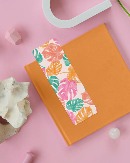 Tropical Monstera Leaf Print Bookmark – Calling all plant lovers! This bold and colorful monstera leaf bookmark brings the tropical vibes with a mix of pink, yellow, orange, and green foliage. Designed in Australia and printed on thick, 100% recycled paper, it’s double-sided, durable, and features rounded corners for a smooth finish. Whether you're reading by the beach, in a cozy nook, or on the go, this vibrant jungle-inspired bookmark will brighten up every book! 🍃📚☀️