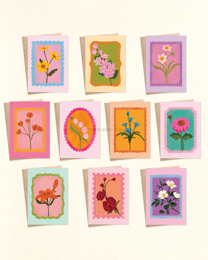A selection of beautifully illustrated greeting cards filled with colourful floral blooms on uniquely shaped stamps. These are a beautiful choice for any occasion—whether it's a birthday, a thank-you, or just because. With ten unique designs, this handmade floral card pack is perfect for celebrating friends, family, and loved ones all year round. Each card is designed with bright, cheerful colours to make someone’s day unforgettable. Our cards are made from 100% post consumer recycled papers.