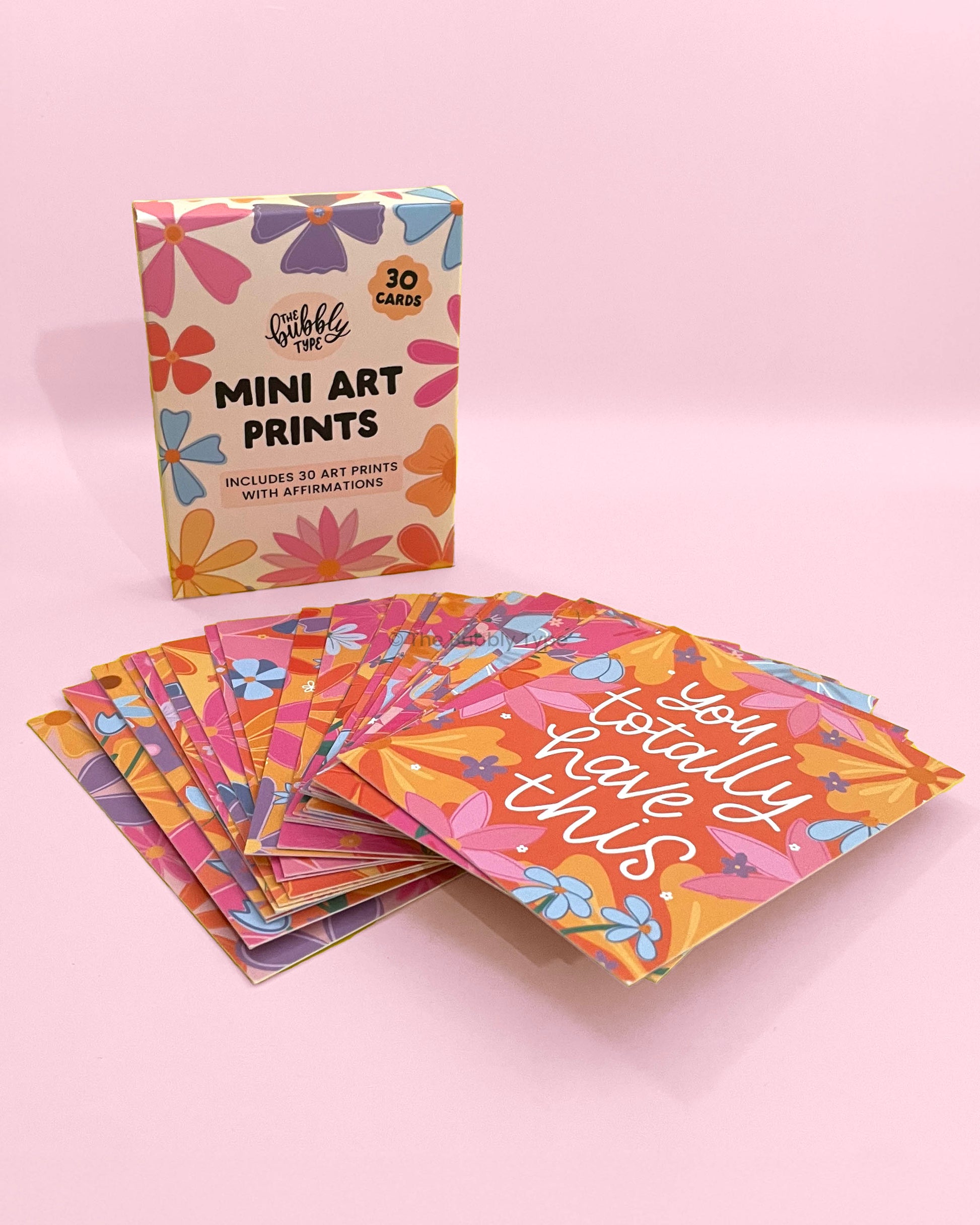 Close up of motivational affirmation mini art prints featuring hand-lettered quotes and floral illustrations, eco-friendly stationery printed on recycled paper in Australia, perfect daily inspiration gift. Complete boxed set of 30 motivational affirmation mini art prints by The Bubbly Type, Australian made inspirational quotes with floral art, sustainable and thoughtful gift idea.
