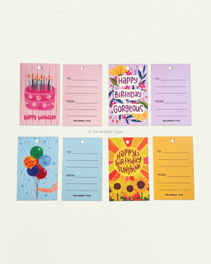 Flat lay of all four birthday tag designs showing front and back. Features party hats, cakes, confetti and more. Great for adding cheer to any birthday gift.