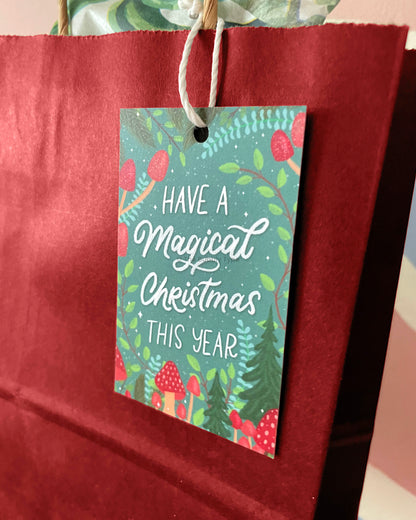 Christmas gift tag attached to a red kraft paper gift bag. Shows how to use the tags for stylish Christmas gift wrapping. Buy unique tags for holiday gifts in Australia.