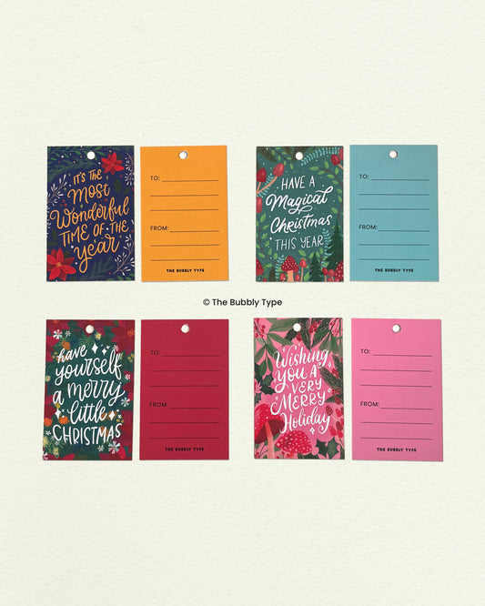 Flat lay of all four Christmas gift tag designs showing front and back. Features classic holiday motifs with space to write a message. Great for festive wrapping ideas in Australia.